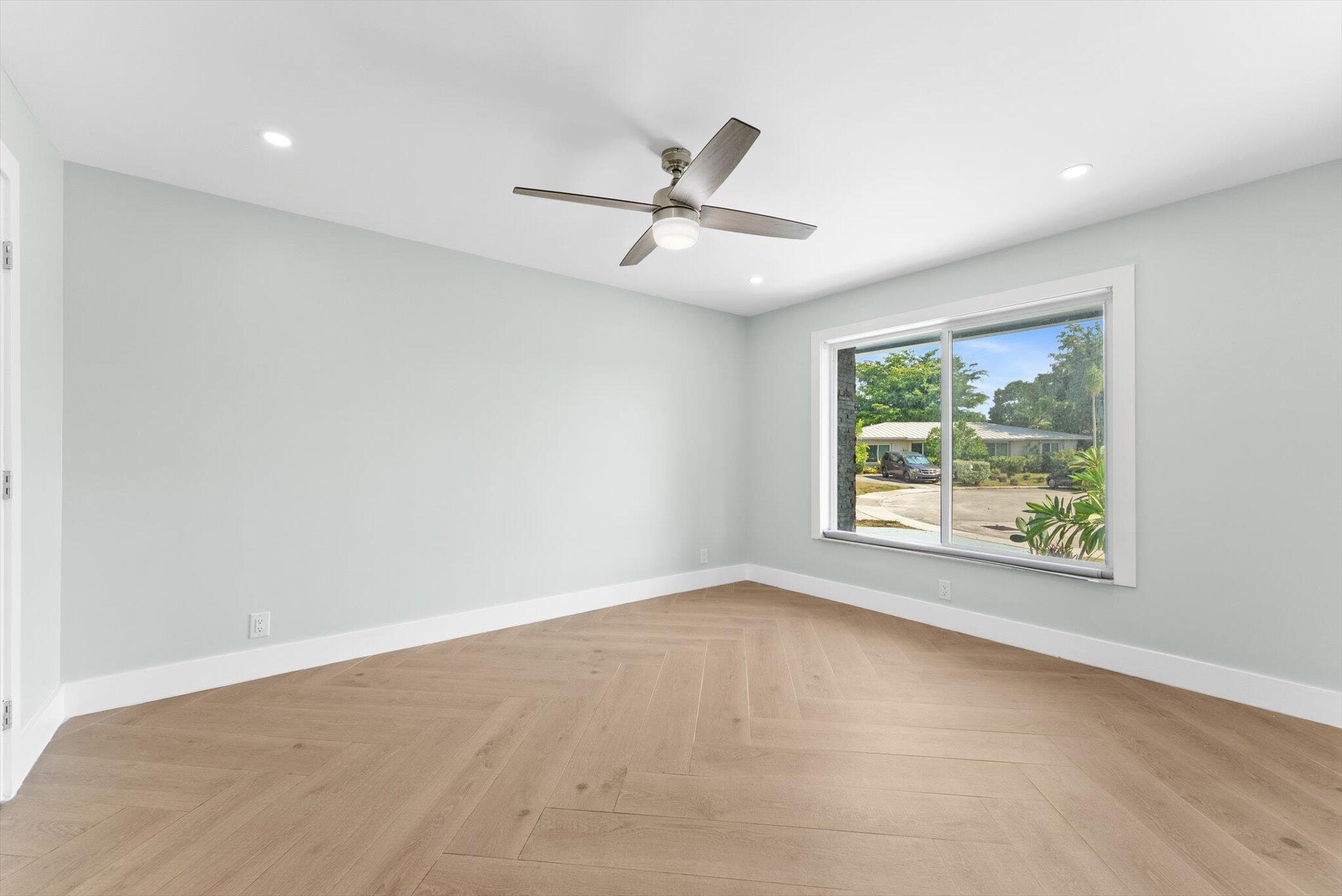 1721 Southwest 10th Street Boca Raton, FL 33486 - Photo 12 of 34 an empty room with windows and ceiling fan