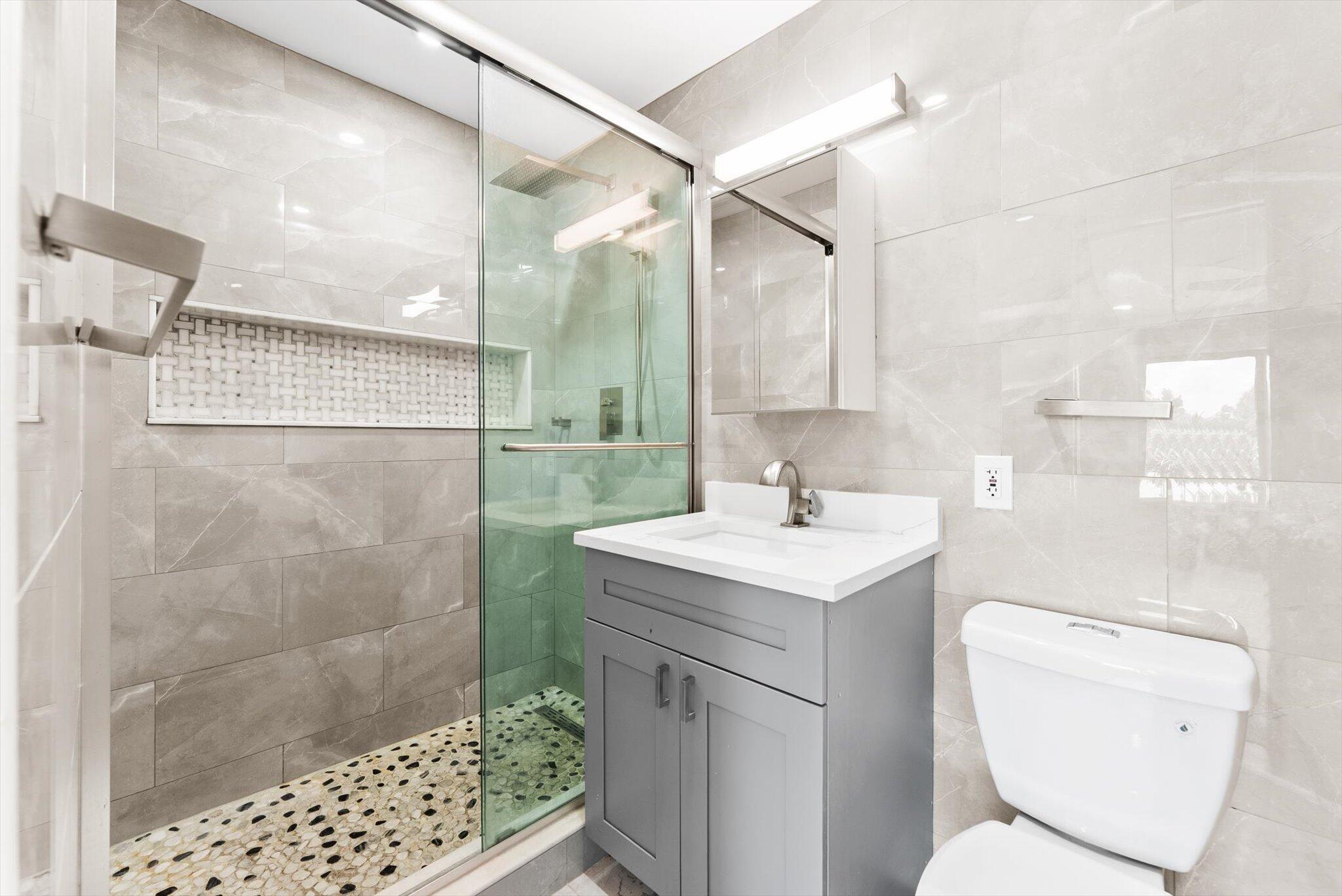 1721 Southwest 10th Street Boca Raton, FL 33486 - Photo 14 of 34 a bathroom with a sink toilet and shower