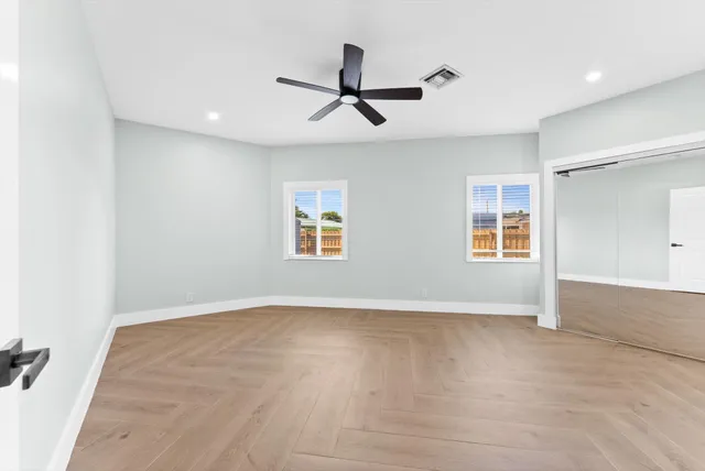 a view of a livingroom with a ceiling fan and window
