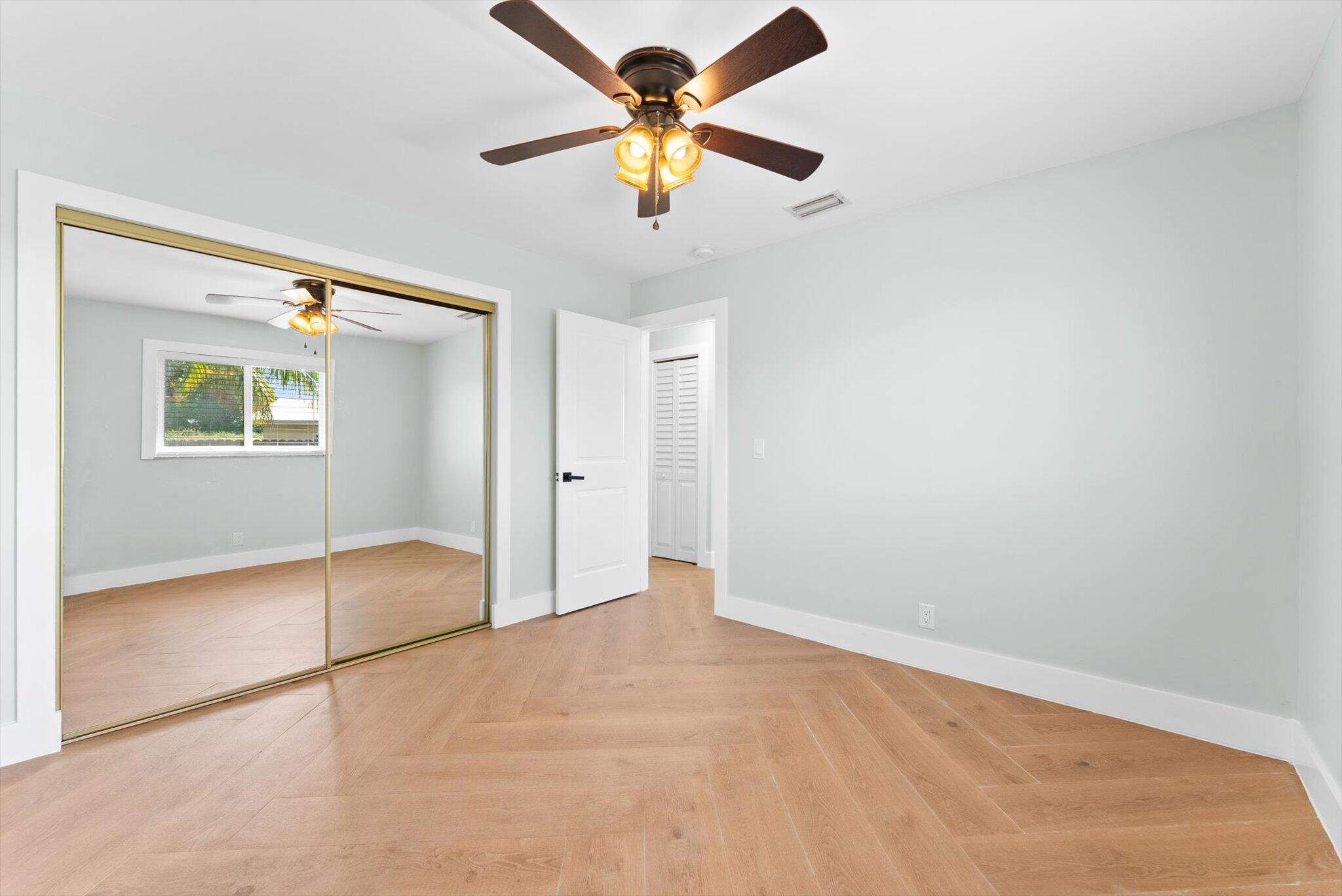 1721 Southwest 10th Street Boca Raton, FL 33486 - Photo 19 of 34 an empty room with closet and fan