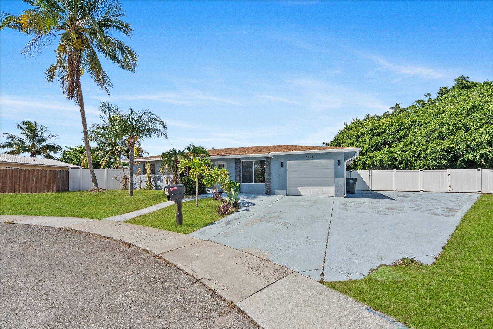1721 Southwest 10th Street Boca Raton, FL 33486 - Photo 2 of 34 a house with palm tree in front of it