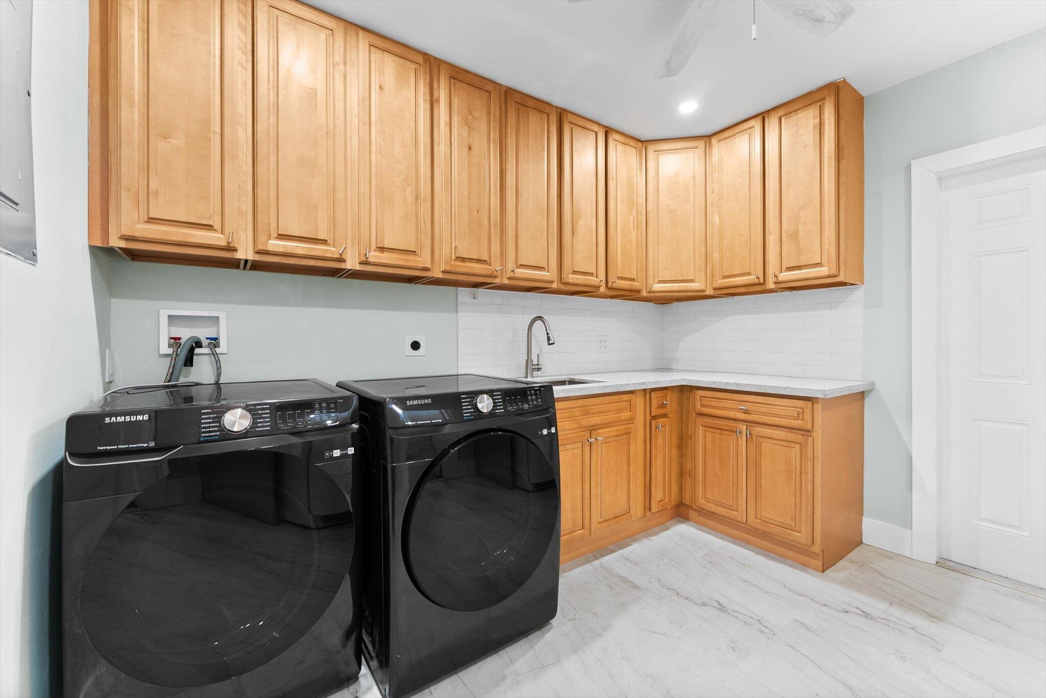 1721 Southwest 10th Street Boca Raton, FL 33486 - Photo 23 of 34 a kitchen with a sink a stove and cabinets
