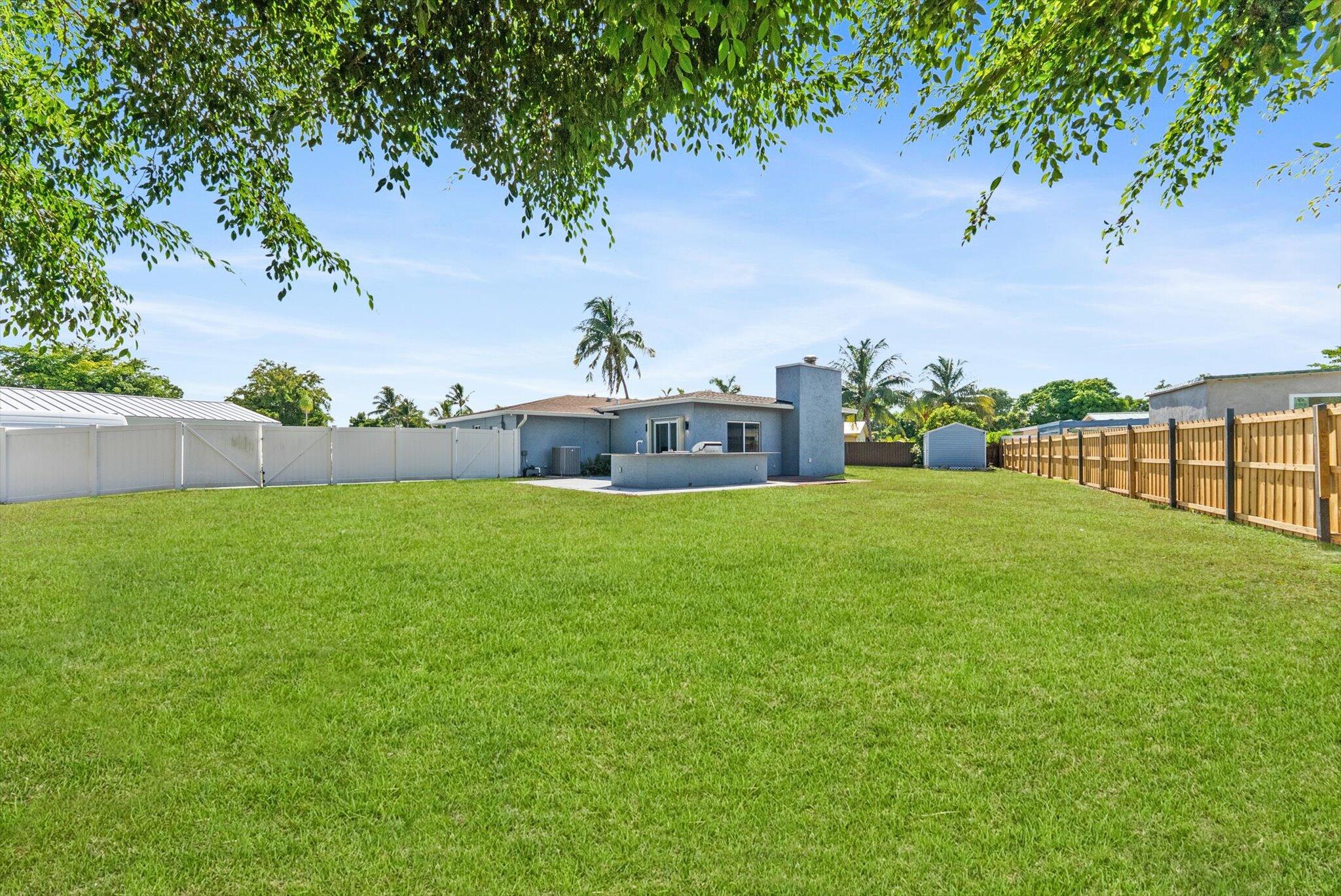 1721 Southwest 10th Street Boca Raton, FL 33486 - Photo 30 of 34 a front view of a house with a yard