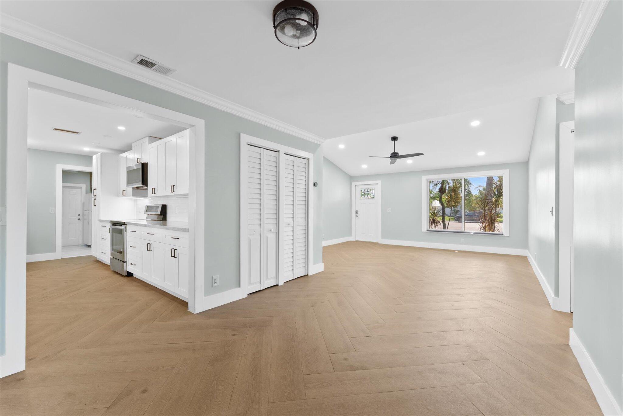 1721 Southwest 10th Street Boca Raton, FL 33486 - Photo 6 of 34 a view of a kitchen with a sink and white cabinets