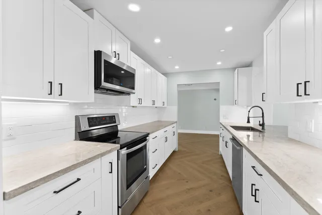 an empty room with a fireplace and windows