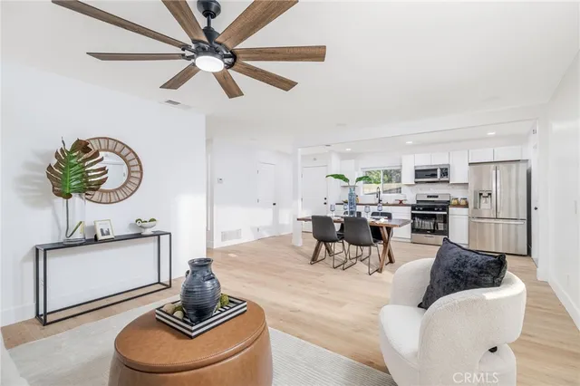 a living room with furniture and a kitchen
