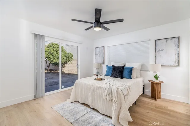 a bedroom with a bed and a large window