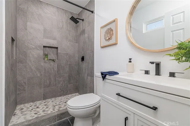 a bathroom with a sink a toilet and a mirror