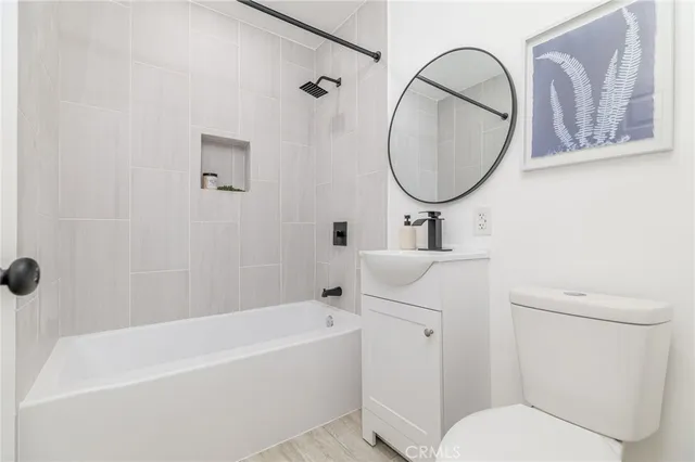a bathroom with a toilet a sink and bathtub