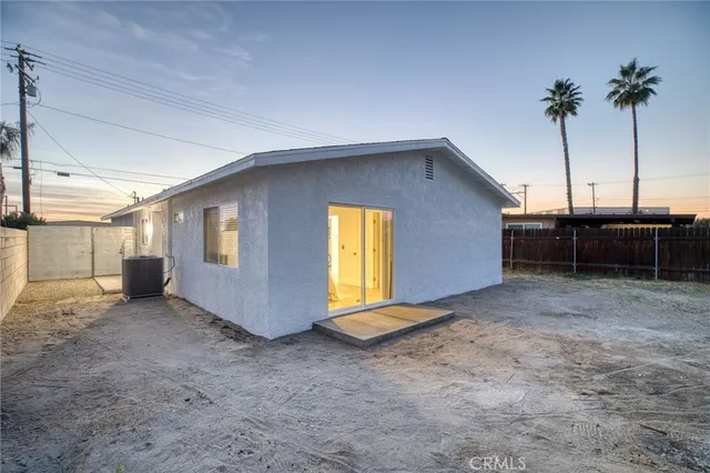a view of a house with a backyard and a garage