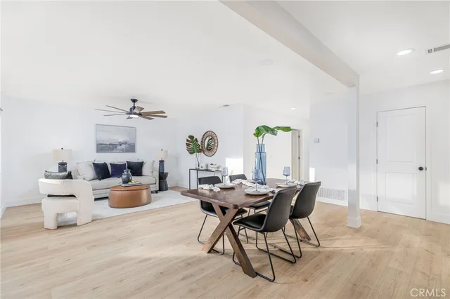 a view of a dining room with furniture and a window