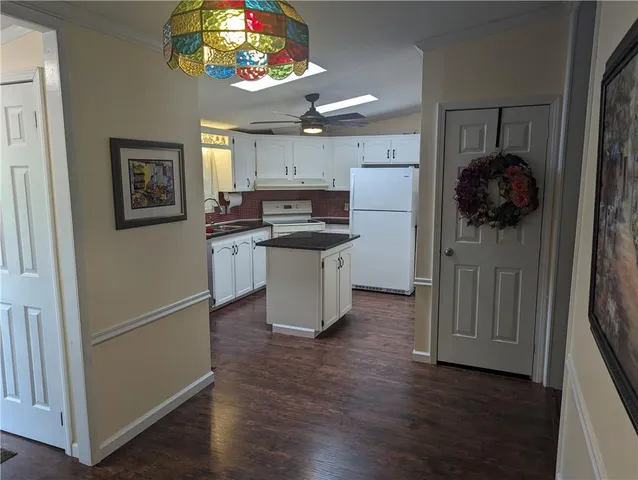 a kitchen with a refrigerator and a stove top oven
