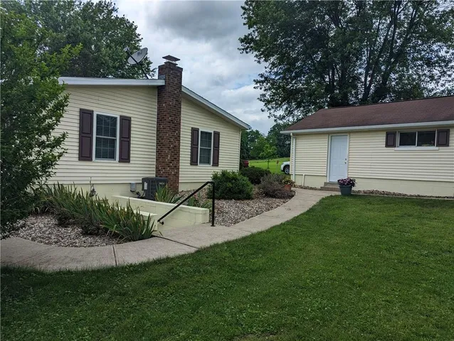 a view of a house with a yard and plants