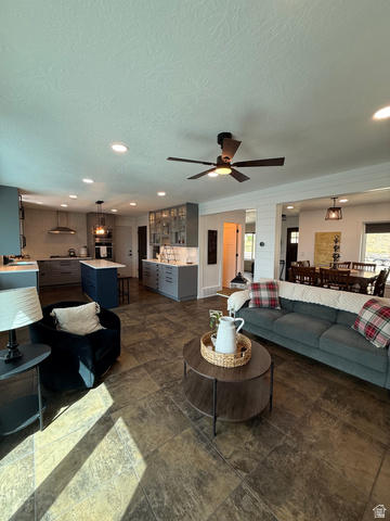 965 North 800 East Springville, UT 84663 - Photo 16 of 46 Living room with a textured ceiling, dark stone finish flooring, ceiling fan, and recessed lighting