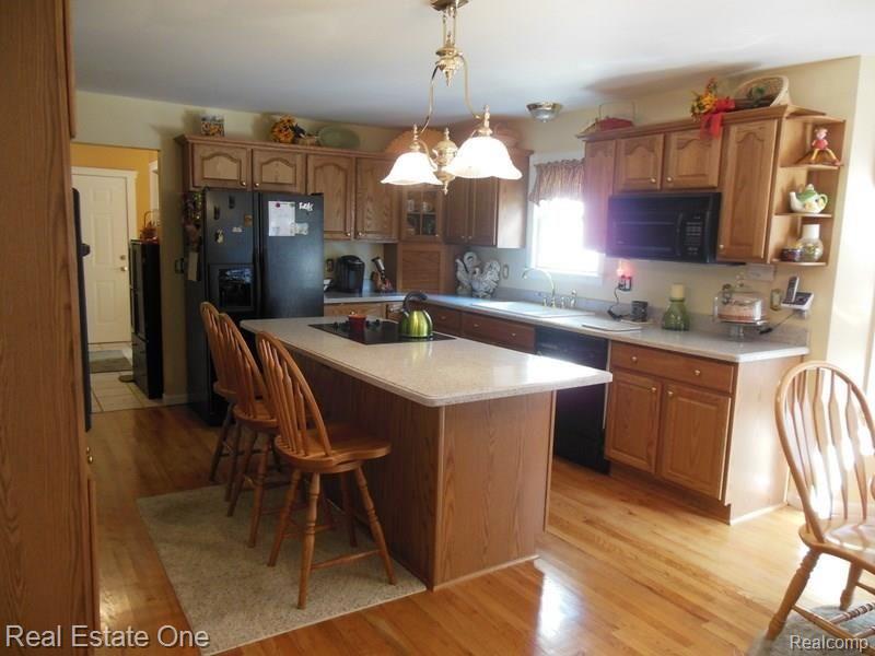 10155 Roberts Road Gregory, MI 48137 - Photo 22 of 89 Oak kitchen, floor and cabinets with pull out drawers and pantry. Cabinets with crown molding