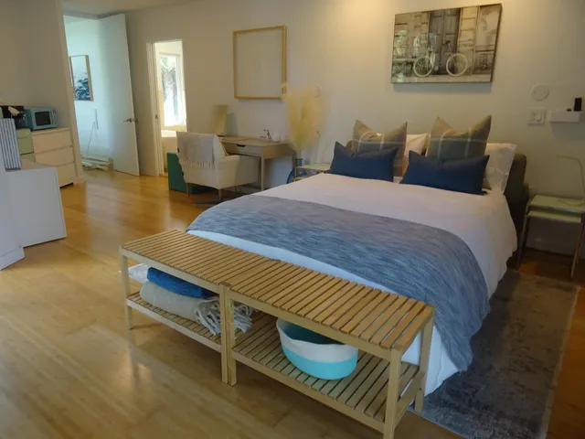 a bathroom with a sink and mirror with bathtub