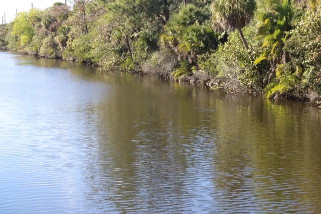 a sign board with building in the background