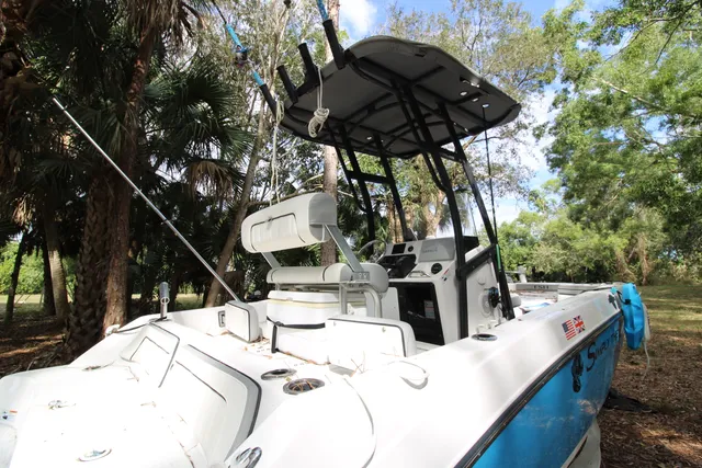 a view of two chairs and table in the patio