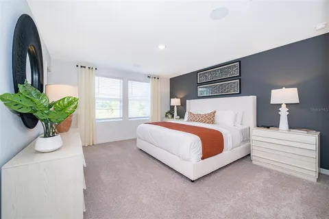 a spacious bedroom with a bed and a cabinets