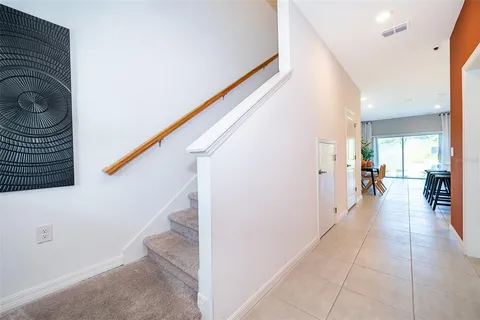 a kitchen with stainless steel appliances kitchen island granite countertop a table chairs sink and cabinets