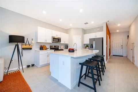 a large white kitchen with lots of counter top space