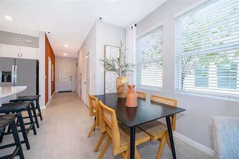 a living room with furniture kitchen view and a table