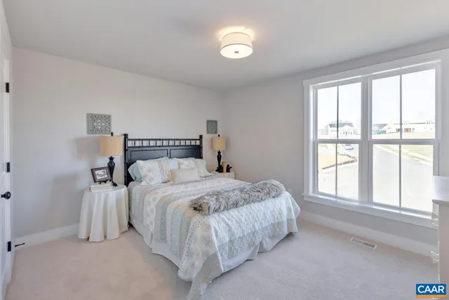 a bedroom with a bed and window