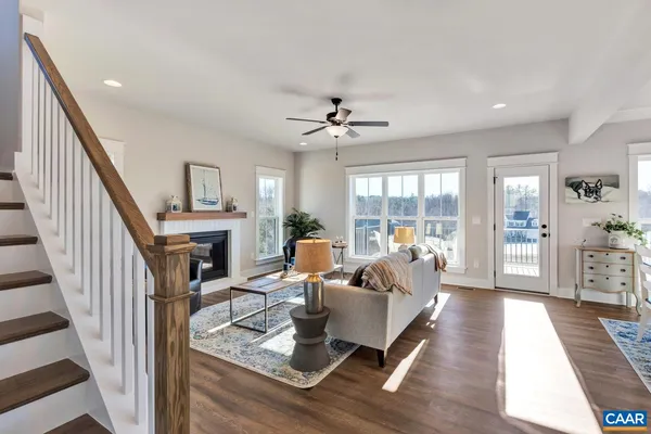 a living room with furniture a fireplace and a window