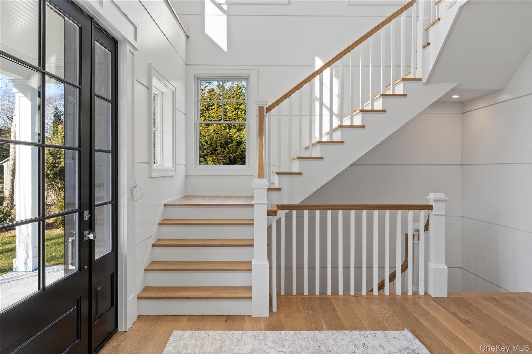 2590 Cox Neck Road Mattituck, NY 11952 - Photo 19 of 50 An impressive foyer with clean architectural lines and natural light creates a memorable first impression
