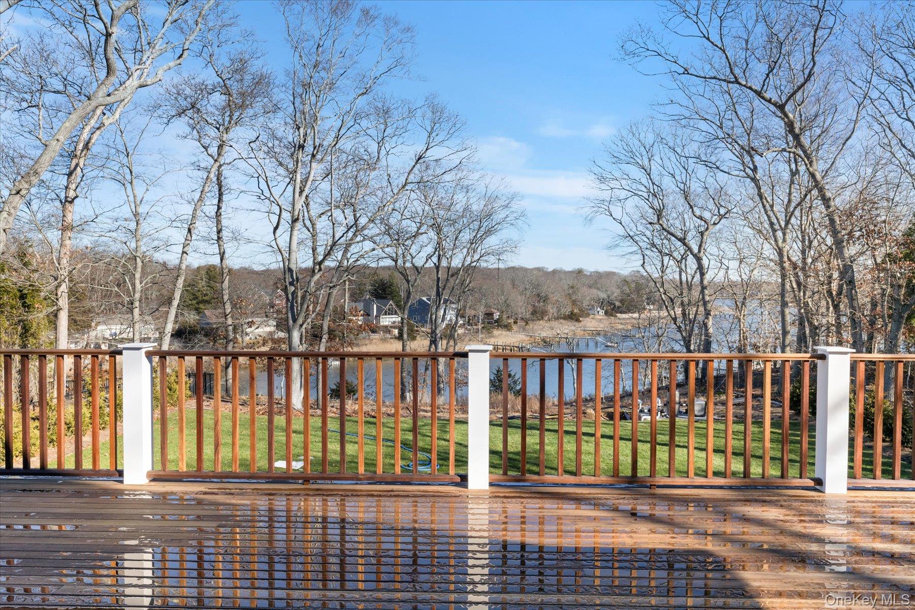 2590 Cox Neck Road Mattituck, NY 11952 - Photo 39 of 50 Expansive mahogany decking creates an ideal setting for outdoor relaxation overlooking the water