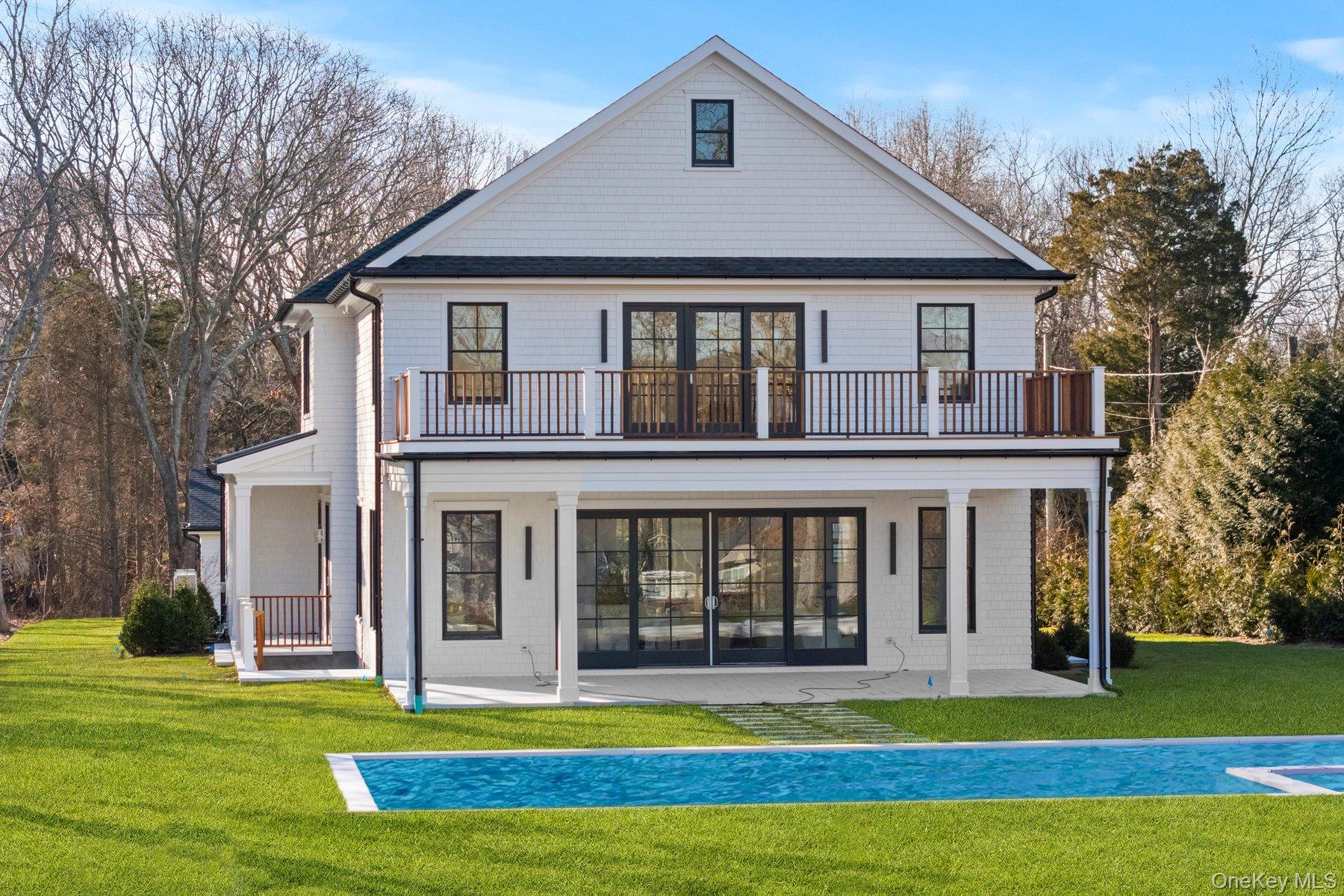 2590 Cox Neck Road Mattituck, NY 11952 - Photo 41 of 50 Back of property with a patio, gunite pool and a balcony