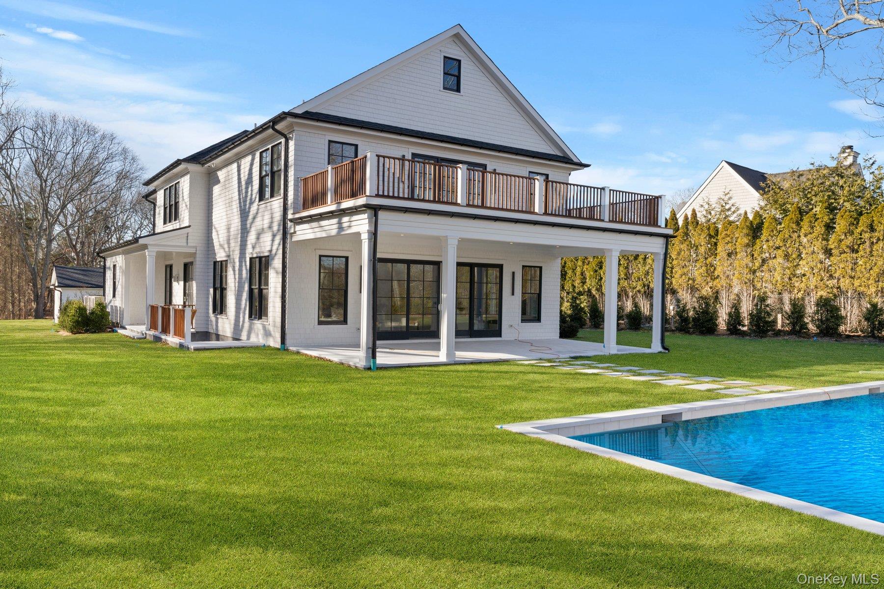 2590 Cox Neck Road Mattituck, NY 11952 - Photo 43 of 50 Back of house featuring a patio, a yard, and an outdoor pool