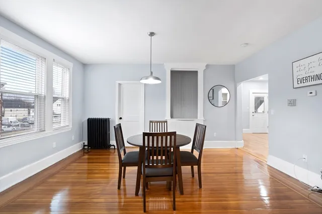 a view of a dining room with furniture window and wooden floor