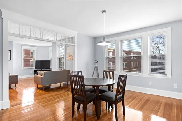 a view of a dining room with furniture window and wooden floor