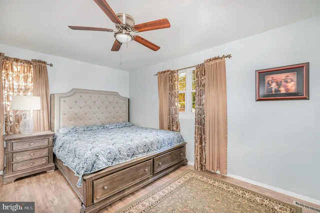 a bedroom with a bed and a painting on the wall