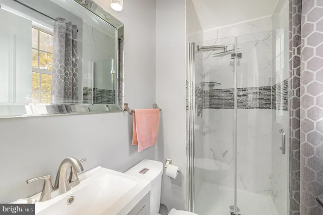 a bathroom with a sink and shower
