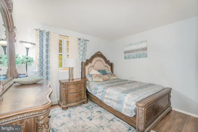 a bedroom with a bed and a large window with the outer view