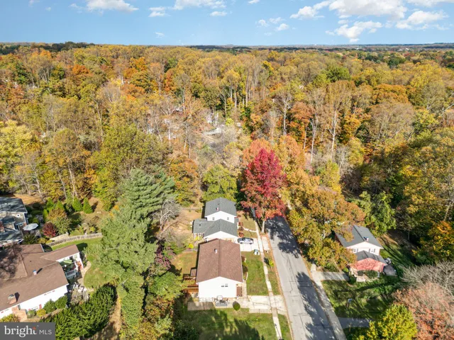 an aerial view of residential houses with outdoor space