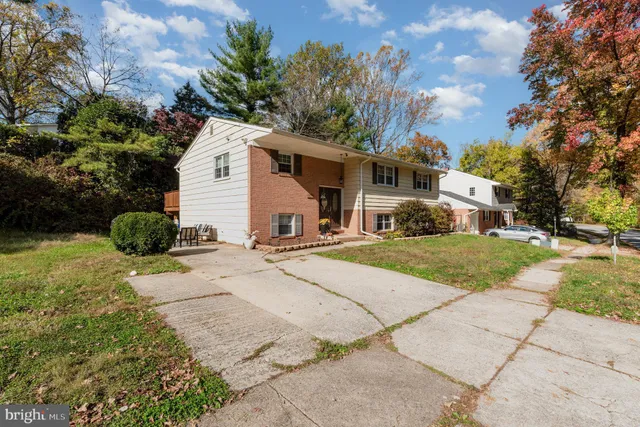 a view of a white house with a yard and plants