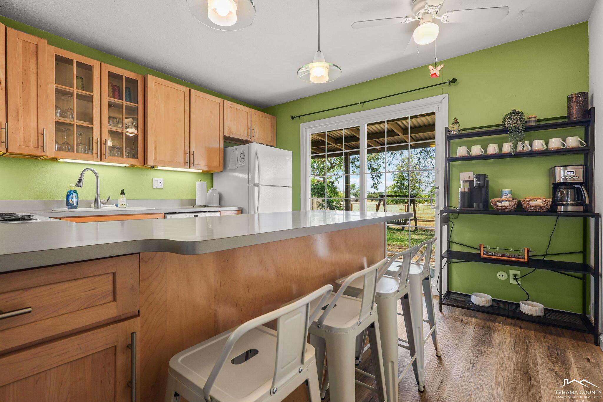 22275 Brent Road Red Bluff, CA 96080 - Photo 9 of 47 a kitchen with a sink window and cabinets