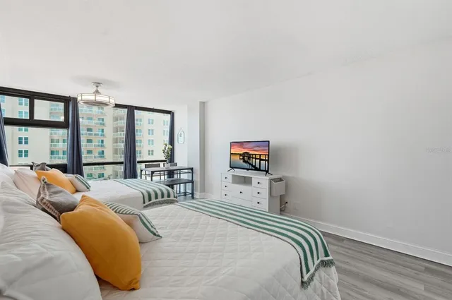 a bedroom with a bed and a flat screen tv