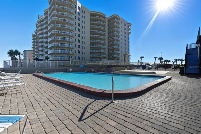 a view of a swimming pool with a lounge chairs