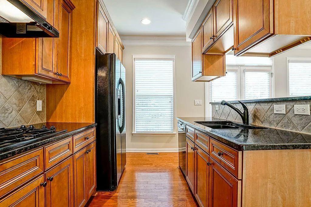 6120 Joybrook Road Duluth, GA 30097 - Photo 16 of 30 a kitchen with stainless steel appliances granite countertop a sink and a stove