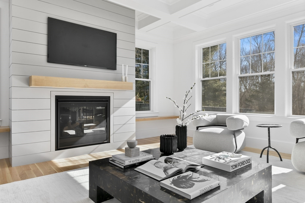 62 Brewster Drive Needham, MA 02492 - Photo 13 of 42 a living room with furniture a fireplace and a flat screen tv