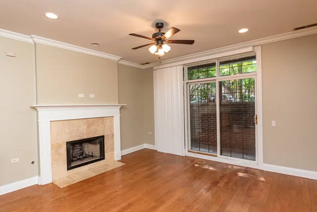 a view of an empty room with a fireplace and a window
