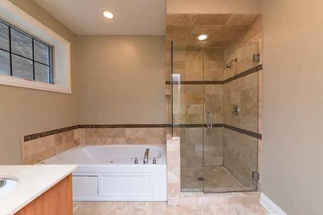 a bathroom with a bath tub and shower