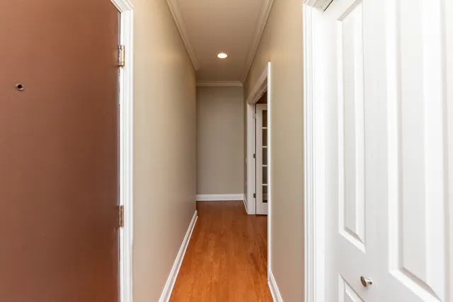 a view of a hallway with wooden floor