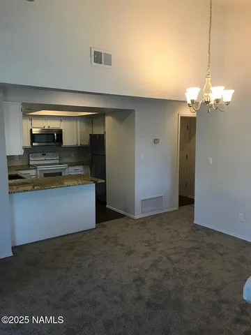 a view of a kitchen from a room