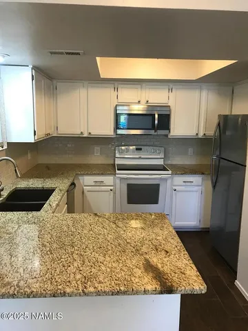 a kitchen with a stove and a sink