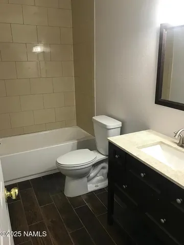 a bathroom with a toilet a sink and bathtub